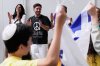 Omer Shem Tov, center, an Israeli hostage who survived over 500 days in Hamas captivity, celebrates while being welcomed during his arrival at Logan Airport, Thursday, May 15, 2025, in Boston. (AP Photo/Charles Krupa)