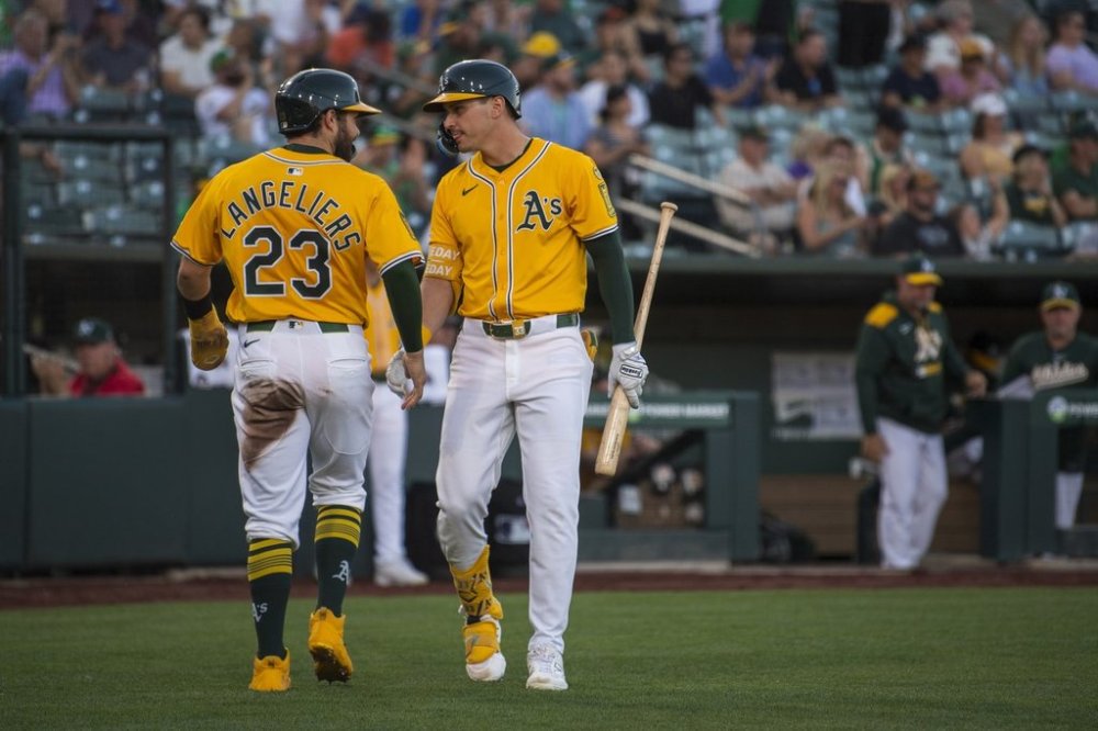 Athletics' JJ Bleday, right, celebrates with Shea Langeliers after he score during the second inning of a baseball game against the Los Angeles Angels in West Sacramento, Calif., Tuesday, May 20, 2025. (AP Photo/Nic Coury)