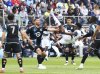 Vancouver Whitecaps forward Emmanuel Sabbi, centre right, scissor kicks the ball against Minnesota United during the second half of an MLS soccer match Sunday, April 27, 2025, in St. Paul, Minn. (AP Photo/Adam Bettcher)