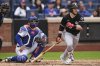 New York Mets catcher Luis Torrens watches as Chicago White Sox's Andrew Benintendi, right, follows through on an RBI triple during the sixth inning of a baseball game Wednesday, May 28, 2025, in New York. (AP Photo/Frank Franklin II)