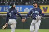 Seattle Mariners' J.P. Crawford, left, celebrates with Julio Rodríguez, right, after they defeated the Chicago White Sox in a baseball game in Chicago, Monday, May 19, 2025. (AP Photo/Nam Y. Huh)
