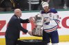 Edmonton Oilers center Connor McDavid (97) is presented with the championship trophy after winning Game 5 of the Western Conference finals in the NHL hockey Stanley Cup playoffs against the Dallas Stars, Thursday, May 29, 2025, in Dallas. (AP Photo/Gareth Patterson)