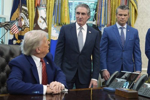 President Donald Trump and Defense Secretary Pete Hegseth listen as Interior Secretary Doug Burgum speaks in the Oval Office of the White House, Friday, May 23, 2025, in Washington. (AP Photo/Evan Vucci)