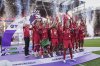 Liverpool players celebrate with the winner's trophy after the English Premier League soccer match between Liverpool and Crystal Palace at the Anfield stadium in Liverpool, England, Sunday, May 25, 2025. (AP Photo/Jon Super)