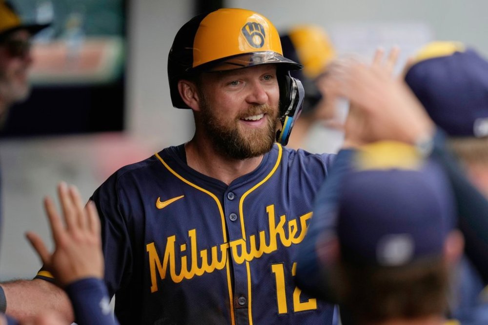 Milwaukee Brewers' Rhys Hoskins is congratulated in the dugout after hitting a home run in the seventh inning of a baseball game against the Cleveland Guardians in Cleveland, Wednesday, May 14, 2025. (AP Photo/Sue Ogrocki)