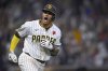 San Diego Padres' Manny Machado celebrates after hitting a home run during the eighth inning of a baseball game against the Miami Marlins, Monday, May 26, 2025, in San Diego. (AP Photo/Orlando Ramirez)
