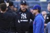 Texas Rangers hitting coach Bret Boone, right, and New York Yankees manager Aaron Boone talk to the officials before a baseball game Tuesday, May 20, 2025, in New York. (AP Photo/Frank Franklin II)
