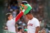 Boston Red Sox's Jarren Duran, left, crowns teammate Rafael Devers with a 