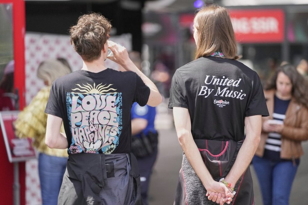 A Eurovision fan promotes love, peace and happiness on a t-shirt ahead of the first semi-final of the 69th Eurovision Song Contest, in Basel, Switzerland, Tuesday, May 13, 2025. (AP Photo/Martin Meissner)