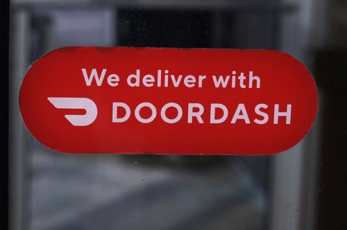 FILE - A DoorDash sign is posted on the door of a Dunkin' Donuts franchise, Feb. 27, 2023, in Methuen, Mass. DoorDash reports earnings on Thursday, Aug. 1, 2024. (AP Photo/Charles Krupa, File)