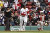 Boston Red Sox's Rafael Devers, center, watches his three-run home run against the Baltimore Orioles during the sixth inning in the first baseball game of a doubleheader Friday, May 23, 2025, at Fenway Park in Boston. (AP Photo/Winslow Townson)