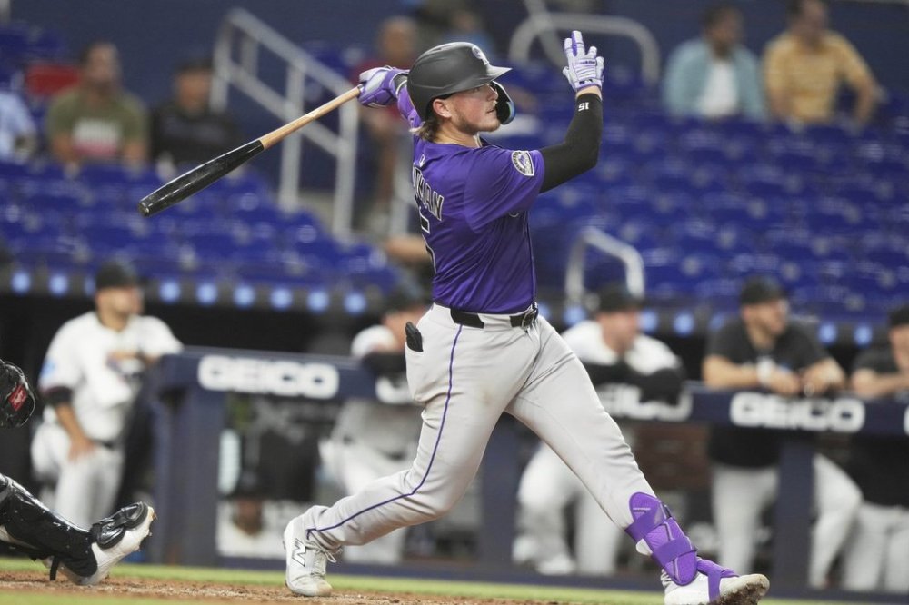Colorado Rockies' Hunter Goodman follows through on a solo home run during the fifth inning of a baseball game against the Miami Marlins, Monday, June 2, 2025, in Miami. (AP Photo/Lynne Sladky)