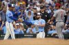 Chicago Cubs' Michael Busch (29), center, slaps hands with third base coach Quintin Berry. left, after hitting a triple during the eighth inning of a baseball game against the Cincinnati Reds, Friday, May 30, 2025, in Chicago. (AP Photo/Erin Hooley)