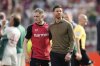 Leverkusen's head coach Xabier Alonso, right, celebrates with Leverkusen's Florian Wirtz at the end of the German Bundesliga soccer match between Bayer Leverkusen and FC Augsburg at the BayArena in Leverkusen, Germany, Saturday, April 26, 2025. (AP Photo/Martin Meissner)