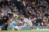 Baltimore Orioles' Ryan O'Hearn, right, hits an RBI single, scoring Gunnar Henderson, during the eighth inning of the second baseball game of a doubleheader against the Boston Red Sox, Saturday, May 24, 2025, at Fenway Park in Boston. (AP Photo/Mary Schwalm)