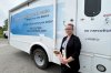 Catalina Friesen, a personal support worker and Low German-speaking liaison, stands in front of a bus outfitted as a mobile walk-in clinic, in St. Thomas, Ont., May 20, 2025. THE CANADIAN PRESS/Hannah Alberga