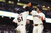 San Francisco Giants' Matt Chapman, right, celebrate with Jung Hoo Lee after hitting a two-run home run during the sixth inning of a baseball game against the San Diego Padres, Wednesday, June 4, 2025, in San Francisco. (AP Photo/Godofredo A. Vásquez)