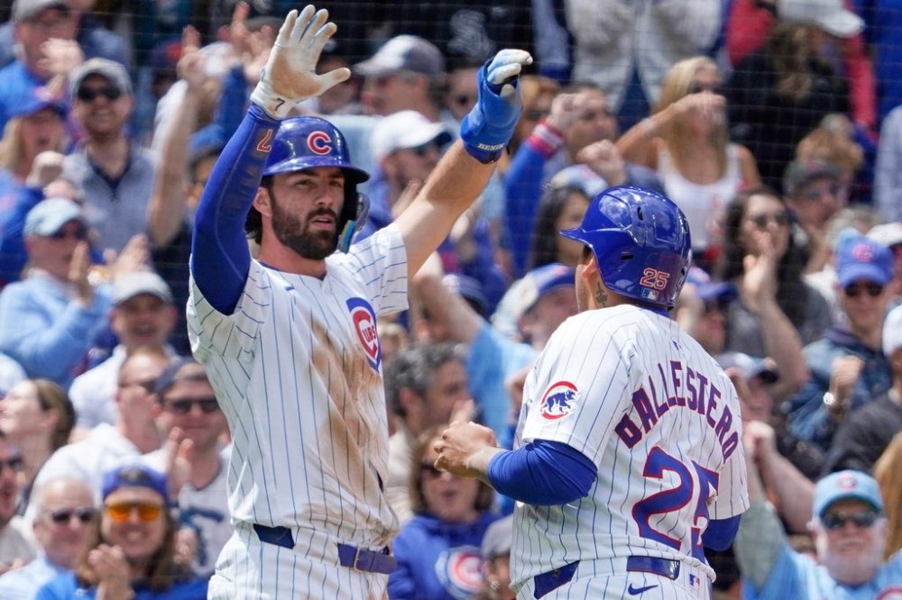 Chicago Cubs' Dansby Swanson, left, and Moisés Ballesteros (25) celebrate after scoring against the Chicago White Sox during the second inning of a baseball game Saturday, May 17, 2025, in Chicago. (AP Photo/David Banks)