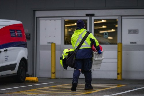 A Canada Post employee returns to a delivery depot in Vancouver, B.C., Tuesday, Dec. 17, 2024. THE CANADIAN PRESS/Darryl Dyck