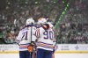 Edmonton Oilers players celebrate after centre Connor McDavid (97) scored against the Dallas Stars during the second period of Game 5 of the NHL's Western Conference final on Thursday, May 29, 2025, in Dallas. (AP Photo/Julio Cortez)
