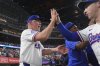 Texas Rangers manager Bruce Bochy, left, celebrates with Wyatt Langford after a baseball game against the Houston Astros, Thursday, May 15, 2025, in Arlington, Texas. (AP Photo/LM Otero)