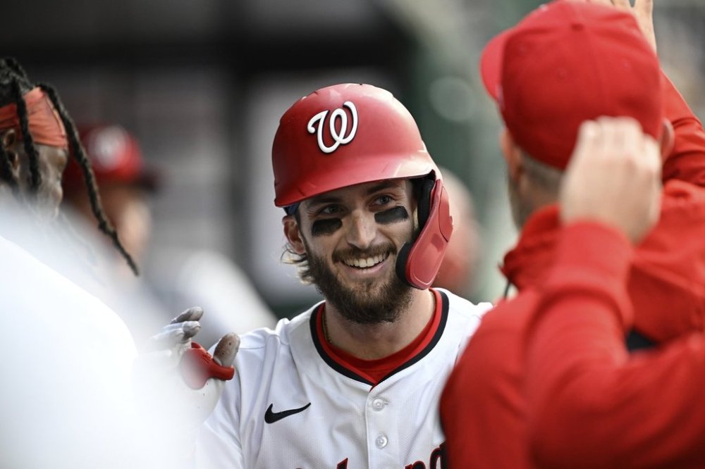 Washington Nationals' Dylan Crews is greeted in the dugout by teammates after hitting a solo home run against Atlanta Braves pitcher Spencer Strider during the second inning of a baseball game in Washington, Tuesday, May 20, 2025. (AP Photo/Terrance Williams)