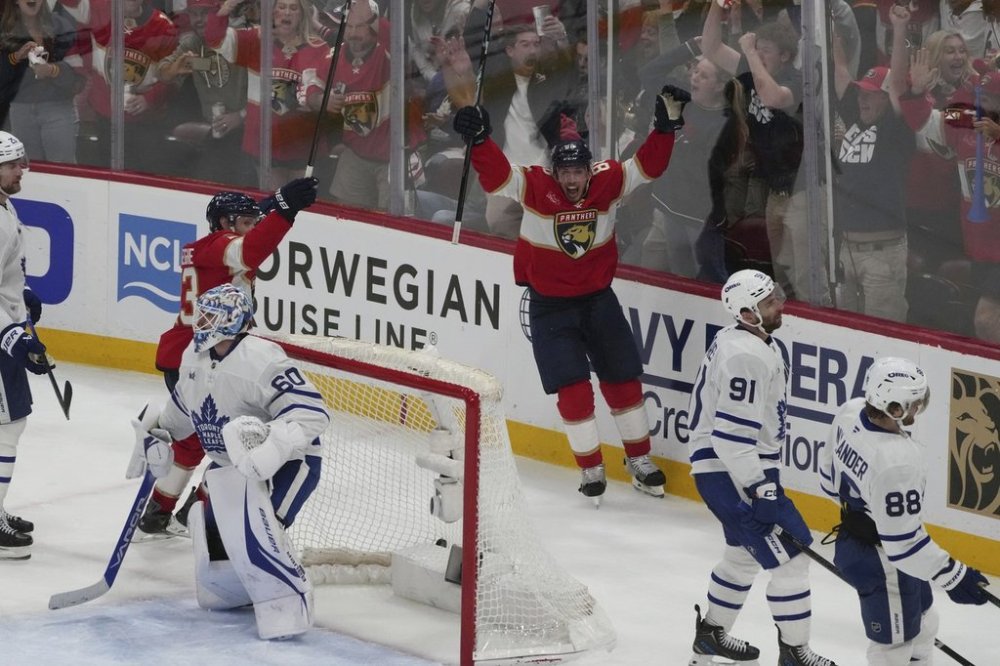 Florida Panthers centre Carter Verhaeghe (23) celebrates after Brad Marchand (63) scored the overtime winner in Game 3 against the Toronto Maple Leafs, Friday, May 9, 2025, in Sunrise, Fla. (AP Photo/Marta Lavandier)