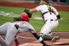 Cincinnati Reds' Elly De La Cruz, left, begins his slide, beating the throw to Pittsburgh Pirates catcher Joey Bart, right, to score on a double by Austin Hays off Pirates pitcher Mitch Keller during the first inning of a baseball game in Pittsburgh, Monday, May 19, 2025. (AP Photo/Gene J. Puskar)