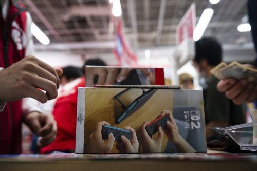 A customer purchases Nintendo Switch 2 at an electronics retailer in Tokyo, Thursday, June 5, 2025. (AP Photo/Louise Delmotte)