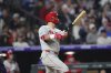 Philadelphia Phillies' Kyle Schwarber follows the flight of his solo home run off Colorado Rockies relief pitcher Ryan Rolison in the seventh inning of a baseball game, Tuesday, May 20, 2025, in Denver. (AP Photo/David Zalubowski)