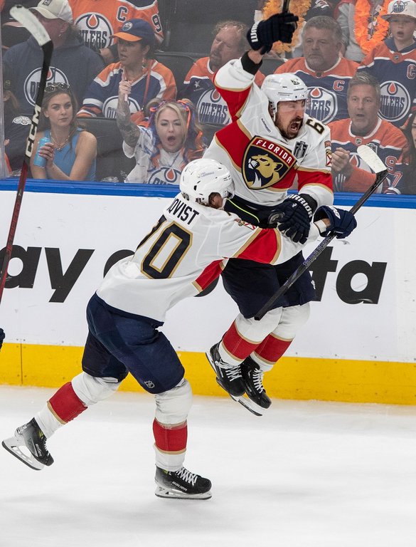 Florida Panthers winger Brad Marchand (63) celebrates his game-winning goal against the Oilers with Jesper Boqvist (70) during the second overtime period in Game 2 of the Stanley Cup final in Edmonton on Friday, June 6, 2025. THE CANADIAN PRESS/Jason Franson