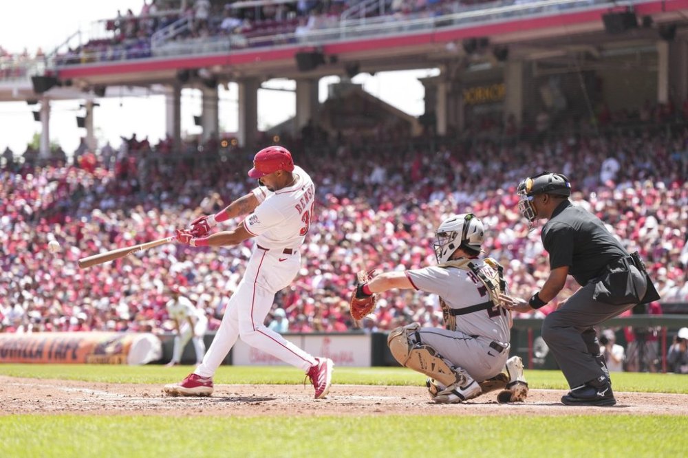 Cincinnati Reds' Will Benson hits a single during the second inning of a baseball game against the Cleveland Guardians, Sunday, May 18, 2025, in Cincinnati. (AP Photo/Jeff Dean)