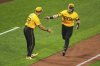 Pittsburgh Pirates' Henry Davis, right, is greeted by third base coach Mike Rabelo (58) as he rounds third after hitting a two-run home run off Philadelphia Phillies pitcher Alan Rangel during the fourth inning of a baseball game in Pittsburgh, Friday, June 6, 2025. (AP Photo/Gene J. Puskar)