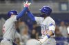 Chicago Cubs' Seiya Suzuki (27) is met by Matt Shaw, left, after hitting a two-run home run during the sixth inning of a baseball game against the Miami Marlins Tuesday, May 20, 2025, in Miami. (AP Photo/Lynne Sladky)
