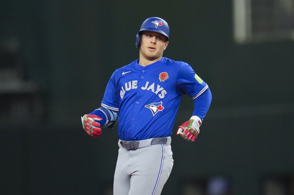 Toronto Blue Jays' Daulton Varsho reaches second base on a double off Texas Rangers starting pitcher Jacob deGrom during the fourth inning of a baseball game, Monday, May 26, 2025, in Arlington, Texas. (AP Photo/Julio Cortez)
