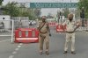 Policemen stand guard on a road leading to the airport in Amritsar, India, after it was closed following India firing missiles into Pakistani-controlled territory, Wednesday, May 7, 2025. (AP Photo/Prabhjot Gill)