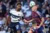 Real Salt Lake's Justen Glad (15) and Vancouver Whitecaps' Ali Ahmed (22) vie for the ball during the second half of an MLS soccer match, in Vancouver, on Saturday, May 3, 2025. THE CANADIAN PRESS/Darryl Dyck