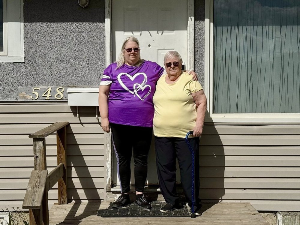 Kyara Moon, 59, and her mother Judy Frank, 78, stand outside their home next to their mailbox in Regina on Friday, May 23, 2025. Moon says they're concerned about a report's recommendation for Canada Post to end of door-to-door mail delivery for residential addresses. THE CANADIAN PRESS/Jeremy Simes