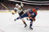 Vegas Golden Knights' Brett Howden (21) is checked by Edmonton Oilers' Troy Stecher (51) during third period round 2, game 4 NHL Stanley Cup playoff action in Edmonton, Monday, May 12, 2025. THE CANADIAN PRESS/Jason Franson