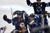 Winnipeg Jets' Adam Lowry (17) celebrates his game-winning goal against the St. Louis Blues with Haydn Fleury (24) in the second overtime period of NHL round one, game seven Stanley Cup playoff action in Winnipeg, Sunday, May 4, 2025. THE CANADIAN PRESS/Fred Greenslade