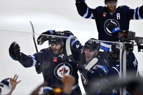 Winnipeg Jets' Adam Lowry (17) celebrates his game-winning goal against the St. Louis Blues with Haydn Fleury (24) in the second overtime period of NHL round one, game seven Stanley Cup playoff action in Winnipeg, May 4, 2025. (Fred Greenslade / The Canadian Press files)