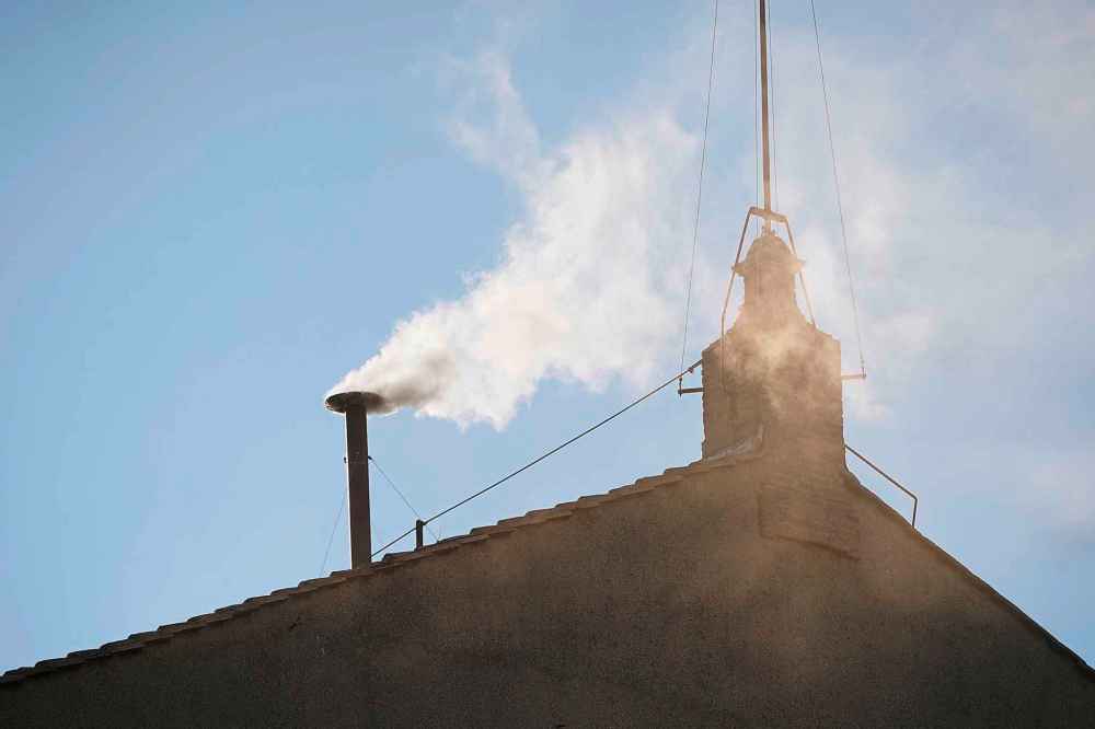White smoke billows from the chimney of the Sistine Chapel during the conclave to elect a new pope, at the Vatican, Thursday, May 8, 2025. (AP Photo/Andrew Medichini)