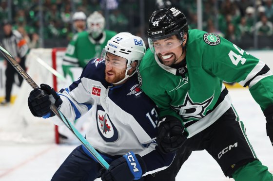 Winnipeg Jets' Gabriel Vilardi (13) and Dallas Stars' Cody Ceci (44) compete for the puck up against the boards in the second period of Game 4. (Gareth Patterson / The Associated Press files)