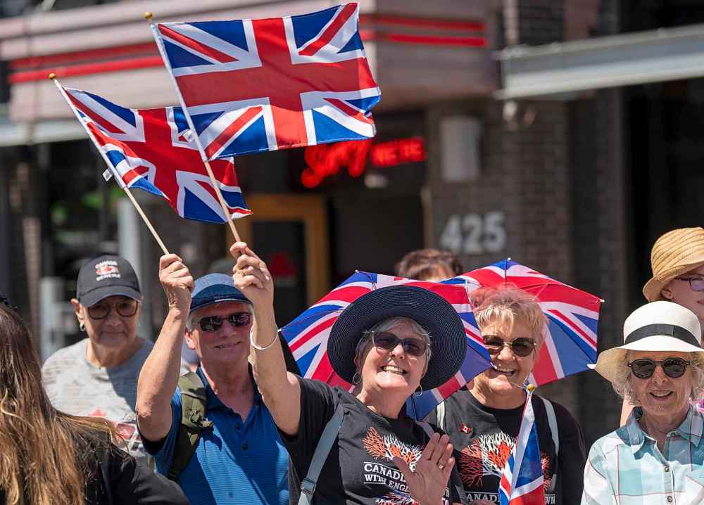 Royal fans wave as they wait for the arrival of King Charles and Queen Camilla at Lansdowne Park in Ottawa on Monday, May 26, 2025. THE CANADIAN PRESS/Christinne Muschi