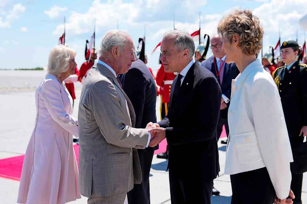 Prime Minister Mark Carney greets King Charles as he and Queen Camilla arrive at the Ottawa International Airport in Ottawa for a royal visit, on Monday, May 26, 2025. THE CANADIAN PRESS/Justin Tang