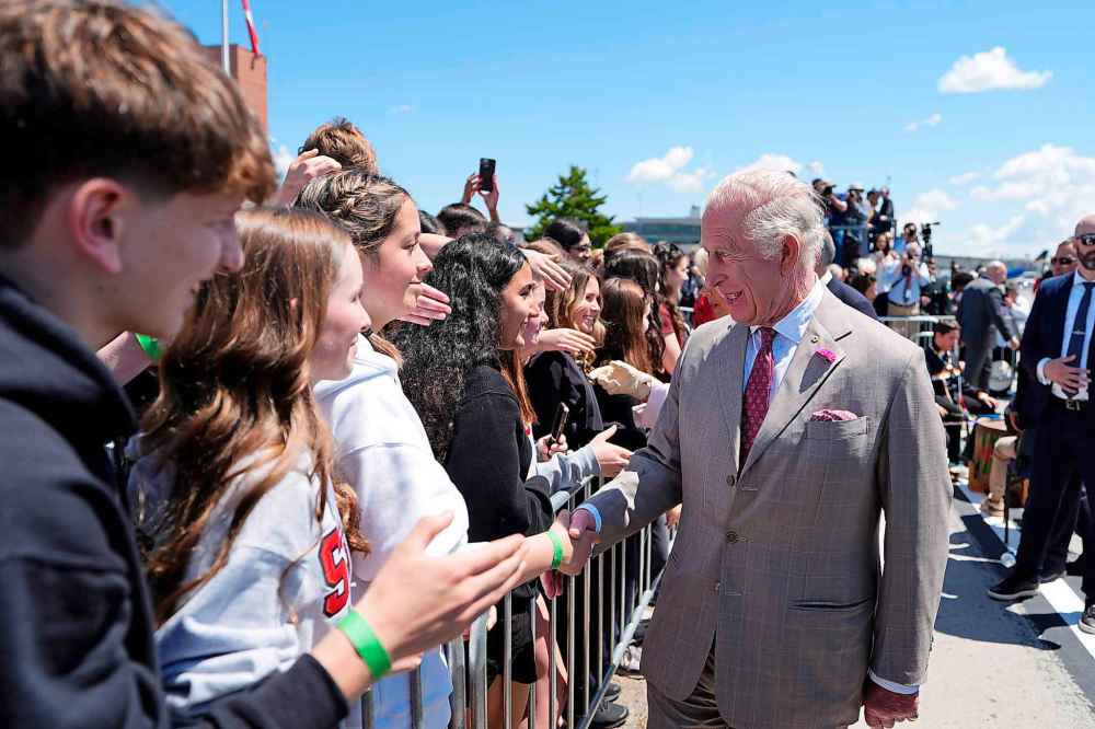 King Charles and Queen Camilla meet students as they arrive at the Ottawa International Airport in Ottawa for a royal visit, on Monday, May 26, 2025. THE CANADIAN PRESS/Justin Tang