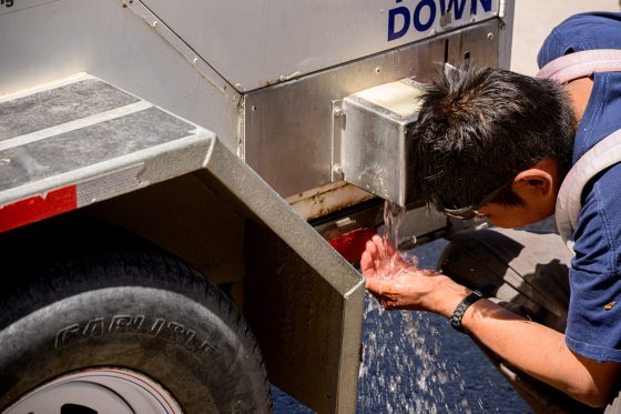 A man uses a hydration station provided by the City of Winnipeg to cool himself down Sunday afternoon. (Mike Sudoma / Free Press)