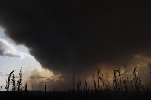 FILE - Wildfire smoke hangs in the air above Highway 97 north of Buckinghorse River, British Columbia, May 30, 2025. (Nasuna Stuart-Ulin/The Canadian Press via AP, File)
