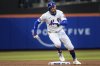 New York Mets' Brandon Nimmo (9) runs back to first base after Juan Soto's hit was caught during the first inning against the Chicago White Sox, Tuesday, May 27, 2025, in New York. (AP Photo/Angelina Katsanis)