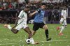 Al Ahli's Ivan Toney, left, attempts a shot at goal in front of Kawasaki Flontale's Kota Takai during to the AFC Champions League Elite final soccer match between Kawasaki Flontale and Al Ahli at Alinma Stadium in Jeddah, Saudi Arabia, Saturday, May 3, 2025. (AP Photo/Ali Issa)